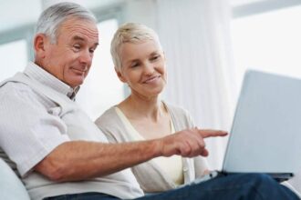 A retired couple review their investing portfolio