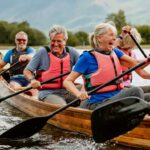 A senior group of friends enjoying rowing on the River Derwent