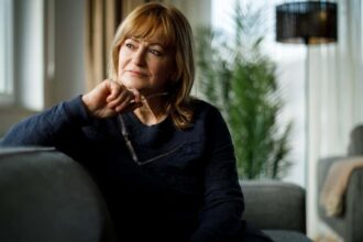 Middle-aged Caucasian woman deep in thought while looking out of the window