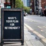 The words "what's your plan for retirement" written on chalkboard on pavement somewhere in London