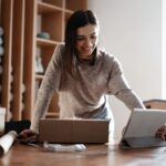 An eBay reseller, working from her home office, organizing and shipping products.