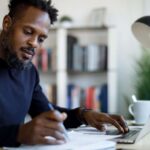 Middle-aged black male working at home desk