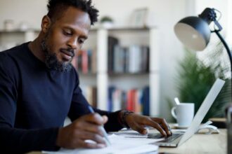 Middle-aged black male working at home desk