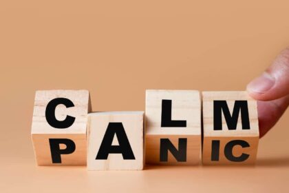 Hand flipping wooden cubes for change wording" Panic " to " Calm".